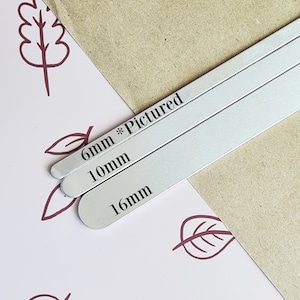 May include: Three silver metal strips with rounded edges, labeled 6mm *Pictured, 10mm, and 16mm. The strips are arranged in a stack, with the largest strip on the bottom and the smallest strip on top.