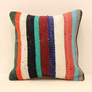 May include: A colorful striped throw pillow with a white background and stripes of red, orange, green, blue, and black.