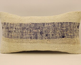 May include: A white and blue throw pillow with a woven texture. The pillow has a single band of blue woven into the white fabric.