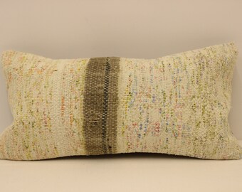 May include: White rectangular pillow with a brown woven stripe down the center. The pillow has a textured, woven fabric with a subtle multi-colored pattern.
