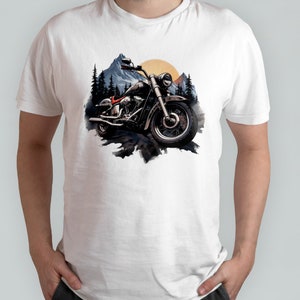May include: A white t-shirt featuring a graphic of a black motorcycle in front of a mountain range with a sunset in the background.