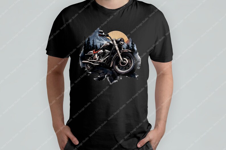 May include: A black t-shirt featuring a graphic of a motorcycle riding through a forest with a sunset in the background.