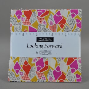 May include: A stack of fabric squares with a colorful geometric pattern in yellow, pink, orange, and black. The fabric is labeled "Looking Forward" by Kingwell Designs, with a ruler on top.