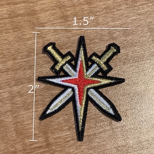 May include: A 2 inch by 1.5 inch embroidered patch featuring a red star with two crossed swords. The swords are gold with white accents. The star has a black outline.