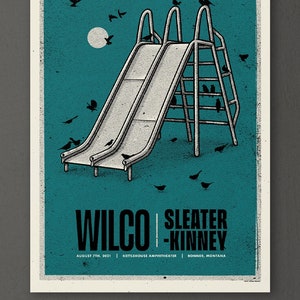 May include: A teal blue poster with a black and white illustration of a slide with birds perched on the top. The poster has the text "WILCO SLEATER-KINNEY" in black text. Below the text is the date "AUGUST 7TH, 2021", the location "KETTLEHOUSE AMPHITHEATER", and the city "BONNER, MONTANA".