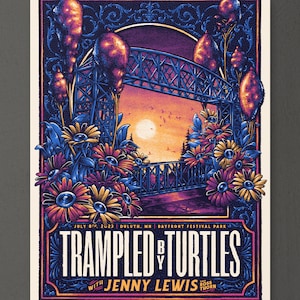 May include: A concert poster for the band "Trampled By Turtles" with Jenny Lewis. The poster features a colorful illustration of a bridge with flowers and a sunset in the background. The text "July 8th, 2023 Duluth, MN Bayfront Festival Park" is at the top of the poster.