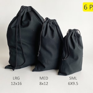 May include: A set of six black drawstring bags in three sizes: large (12x16 inches), medium (8x12 inches), and small (6x9.5 inches).