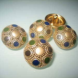 May include: Four gold-toned buttons with a textured surface and a pattern of blue, green, and black dots.
