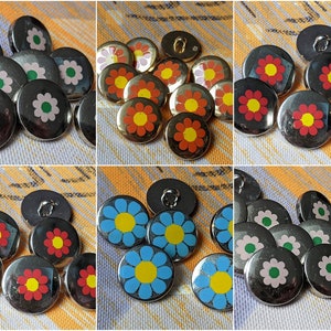 May include: Assortment of colorful flower-shaped buttons with silver metal backing. The buttons feature a variety of colors, including red, yellow, blue, and green.