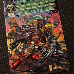 May include: A comic book cover for "Cyber Force" featuring a group of action figures with weapons. The cover has a green and black title, with the word "IMAGE" and the number "1" visible. The comic is set against a dark background.