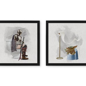 May include: Two framed watercolor illustrations. The first shows a Mandalorian character sitting on a toilet with a rifle. The second shows a Baby Yoda character sitting on a potty with a roll of toilet paper.