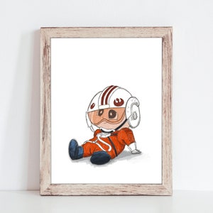 May include: A framed print featuring a cartoon illustration of a character in an orange pilot suit and helmet with a red and white design. The character is sitting down with blue boots. The artwork is in a wooden frame.