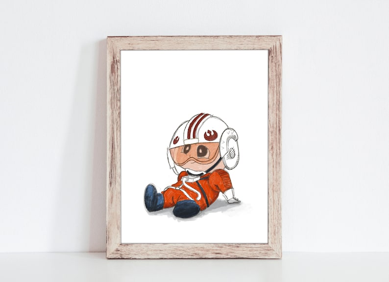 May include: A framed print featuring a cartoon illustration of a character in an orange pilot suit and helmet with a red and white design. The character is sitting down with blue boots. The artwork is in a wooden frame.