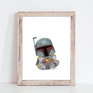 May include: Watercolor print of a cartoon Boba Fett character in a seated position, holding a small object. The character wears a gray and red helmet and armor. The artwork is framed in a light brown wooden frame.