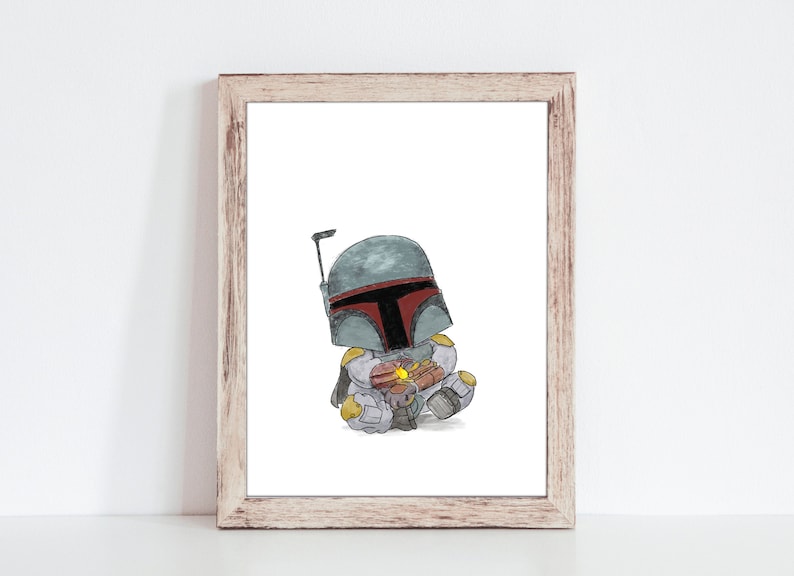 May include: Watercolor print of a cartoon Boba Fett character in a seated position, holding a small object. The character wears a gray and red helmet and armor. The artwork is framed in a light brown wooden frame.