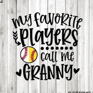 May include: Black and white text on a woodgrain background reads "My favorite players call me Granny" with a heart on each side of the word Granny. A softball with red stitching and a yellow background is in the center of the text.