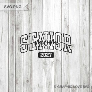 May include: Black graphic design on a light wood background. The design says "SENIOR mom 2027" in a bold, outlined font. The word "mom" is in a cursive font. The year "2027" is in a black rectangle.