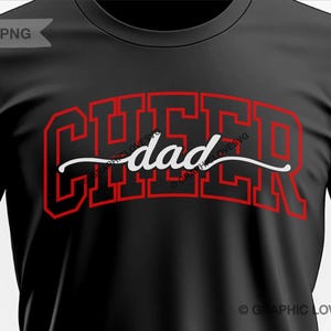 May include: Black t-shirt with red text that says "Cheer dad" in a varsity style font.