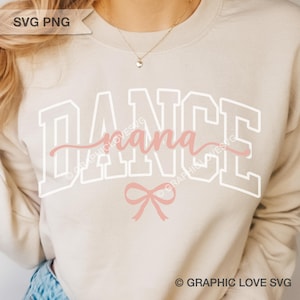 May include: Beige sweatshirt with the text "DANCE nana" in white and pink. The word "DANCE" is in a block letter style, with "nana" in a cursive font. A pink bow is below the text. The sweatshirt is a casual style.