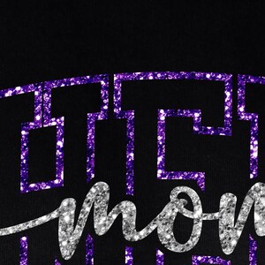 May include: Black background with the word "mom" in silver glitter script. Above the word "mom" is a purple glitter design. The design is a series of connected geometric shapes.