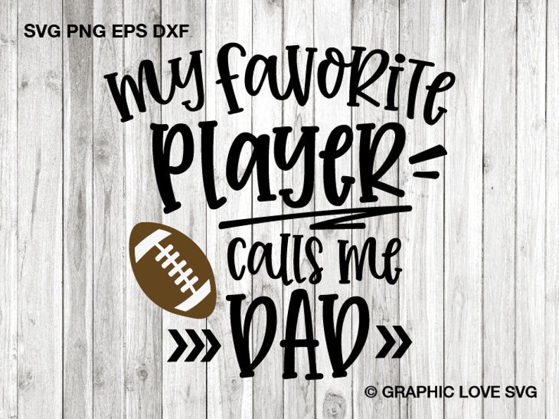 May include: Black and white graphic text on a woodgrain background that reads "my favorite player calls me DAD" with a brown football graphic to the left of the text.