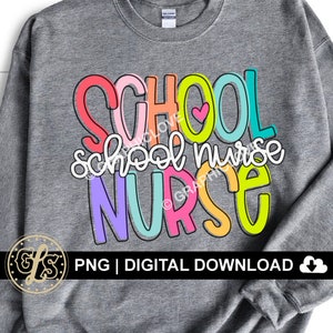 May include: A gray sweatshirt with the text "SCHOOL school nurse NURSE" in colorful letters. The letters are outlined in black and have a rainbow color scheme. A small pink heart is included in the text.