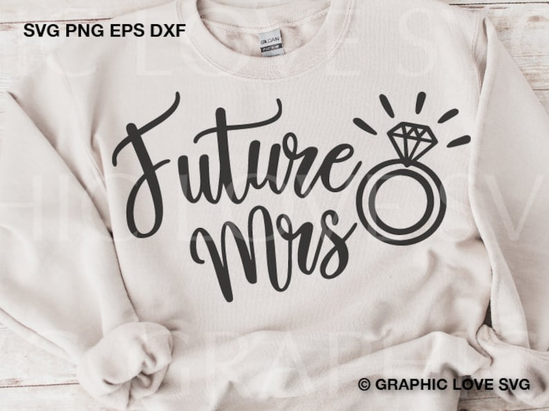 May include: A white sweatshirt with the text "Future Mrs." in black cursive lettering. A black ring with a diamond is above the text.