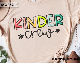 May include: A beige t-shirt with the text "Kinder crew" in rainbow colours with an arrow pointing to the right.