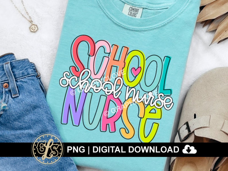 May include: A turquoise blue t-shirt with the text "SCHOOL school nurse NURSE" in colorful, outlined letters. The letters are in a variety of colors, including pink, yellow, green, and purple.