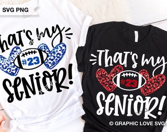 May include: A white t-shirt and a black t-shirt, each featuring the text "That's my SENIOR!" in black and white script. Between the words are two leopard-print hearts flanking a football graphic with the number "#23" in blue or red glitter.