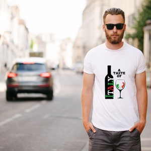 Peut inclure: T-shirt blanc avec un motif noir et rouge d'une bouteille de vin avec le mot "ITALIE" dessus. Le motif comprend &eacute;galement un verre de vin aux couleurs du drapeau italien.