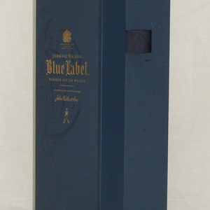 May include: A blue box with gold lettering for Johnnie Walker Blue Label Blended Scotch Whisky. The box has a gold crest and the words "Johnnie Walker" and "Blue Label" are printed in gold.