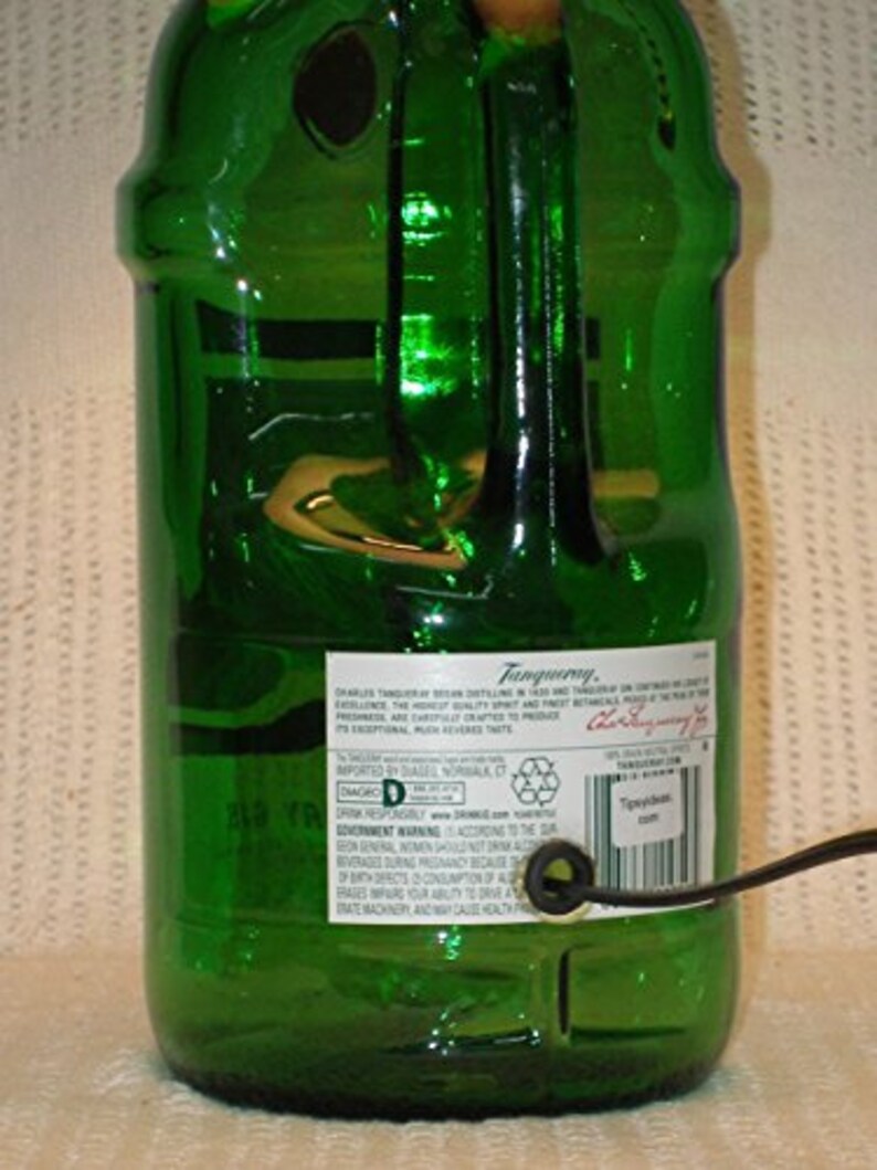 May include: A green glass bottle with a label that reads "Tanqueray" and "Distilled London Dry Gin". The bottle is a decorative lamp with a cord and plug.