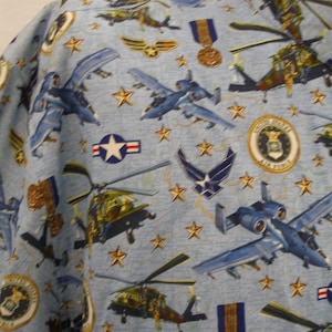 May include: Blue fabric with a repeating pattern of military aircraft, helicopters, stars, and the Air Force seal. The fabric has a light blue background with a subtle texture.