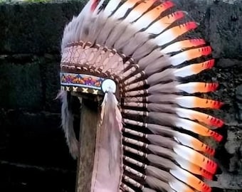 Medium Indian Headdress Replica made with white swan feathers painted red , black , yellow and beaded work in the front