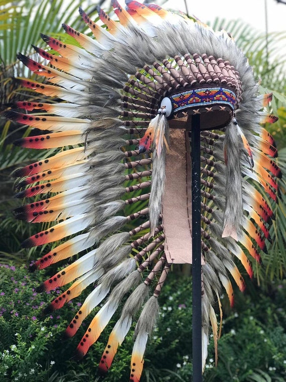 Medium Indian Headdress Replica made with white swan feathers painted red , black , yellow and beaded work in the front
