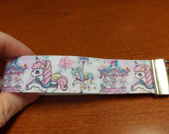 Unicorn wristlet, zipper pull, charm, on white poly strapping, kawaii, cute, carousel