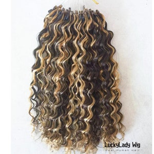 May include: A bundle of curly hair extensions in black and blonde, tied with a gold ribbon. The hair is tightly curled and appears to be real human hair. The text "LuckyLady Wig Real Human Hair" is visible.