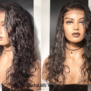 May include: A long, wavy, dark brown human hair wig with a lace front. The wig is styled with loose waves and is worn on a mannequin head. The wig is labeled "LuckyLady Wig Real Human Hair".