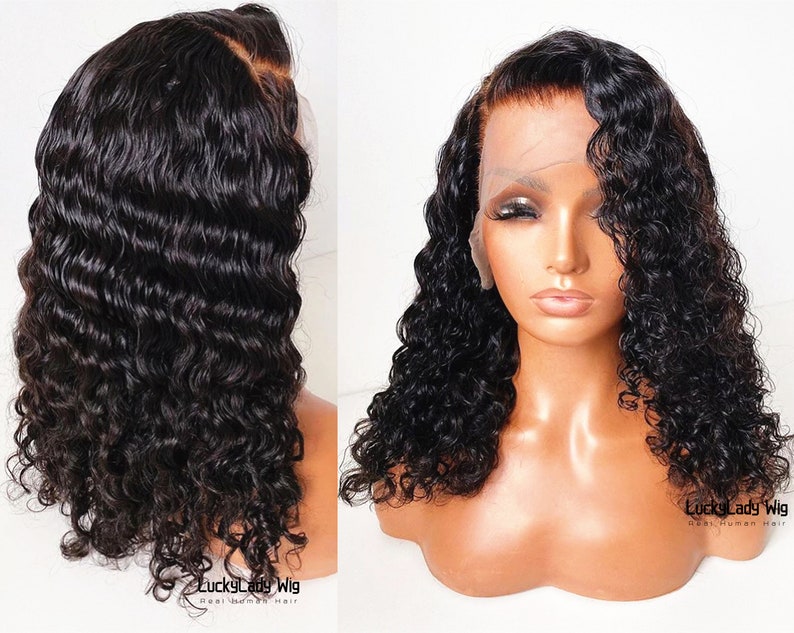 May include: A black human hair wig with loose, curly waves. The wig is styled in a side part and has a lace front. The wig is on a mannequin head.