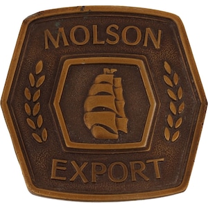 May include: A brown metal belt buckle with the words "Molson Export" and a ship with sails in the center.