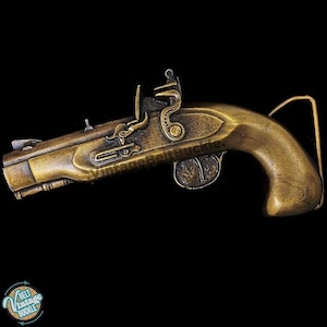 May include: A gold-tone belt buckle shaped like a vintage pistol. The buckle has intricate details and a realistic design.