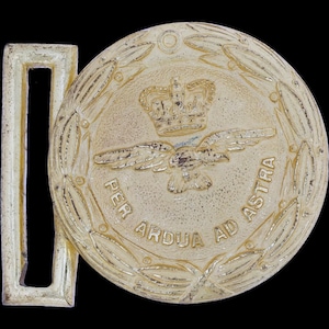 May include: A gold-colored metal belt buckle with the words "PER ARDUA AD ASTRA" encircling a central emblem. The emblem features a crown above a bird with outstretched wings, surrounded by a laurel wreath. The buckle has a rectangular frame.