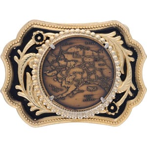 May include: A gold-toned metal belt buckle with a black border and a detailed map of Alaska in the center. The buckle has a decorative floral design and a beaded edge, creating a vintage aesthetic.