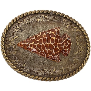 May include: A gold-toned belt buckle with an ornate design featuring a brown and orange arrowhead.