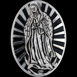 May include: Oval-shaped silver pendant featuring a detailed depiction of the Virgin Mary with hands clasped in prayer. The figure is set against a backdrop of radiating black and silver stripes, with a black background.