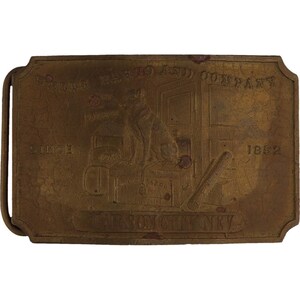 May include: A brass belt buckle featuring an image of a man working in a workshop. The buckle reads "Wm. Barr & Co. Company Since 1852 New York City NY".