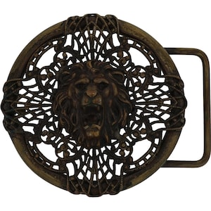 May include: A vintage bronze-toned belt buckle featuring a roaring lion's head at the center. The lion is surrounded by an ornate, openwork circular design. The buckle has a rectangular bar for the belt strap.