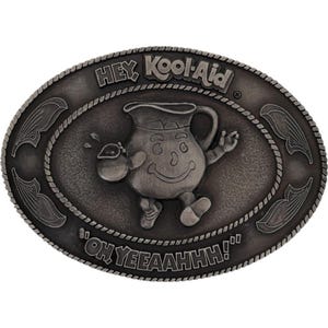 May include: Silver-coloured, oval belt buckle featuring the Kool-Aid Man character. The buckle has the words "HEY Kool-Aid" and "OH YEEAAHH!!" in raised lettering. The Kool-Aid Man is smiling and holding a small pitcher.