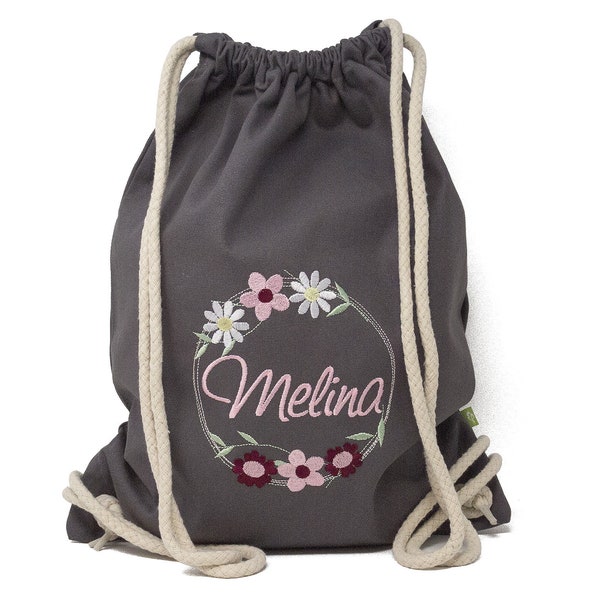 Drawstring bag embroidered with name and floral motif